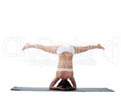 Rear view of young athletic girl doing handstand