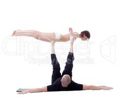 Man and girl doing yoga in studio. Bird Pose.