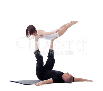 Flexible yoga instructors practising in studio