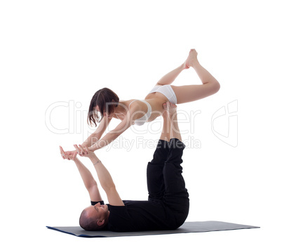 Pair of healthy yoga trainers practising in studio