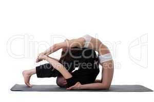 Side view of healthy couple doing yoga in studio