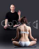 Smiling levitating man looks at woman meditates