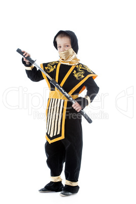 Little boy posing in ninja costume with katana