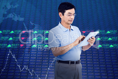 Composite image of man using digital tablet while standing
