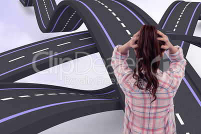 Composite image of brunette with hands on hair in front of stick