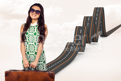 Composite image of asian woman holding luggage