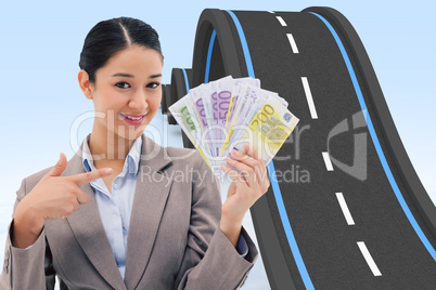 Composite image of smiling businesswoman holding bank notes