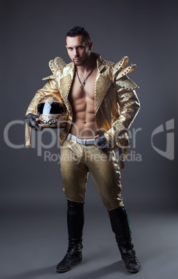 Studio shot of hot muscular man in golden costume