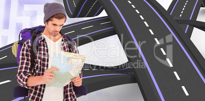 Composite image of man with luggage looking in map