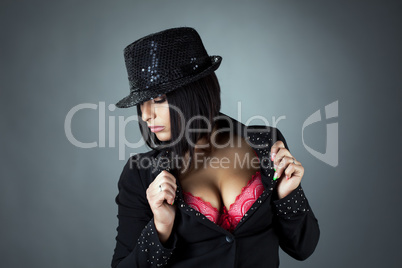 Portrait of hot busty brunette posing in hat