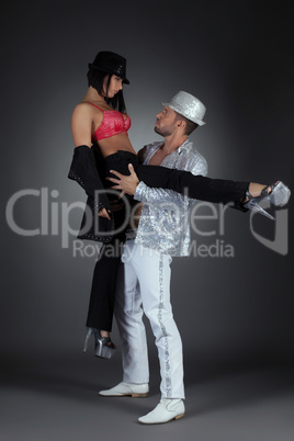 Couple of passionate dancers, on gray backdrop