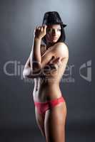 Hot tanned brunette posing topless in hat