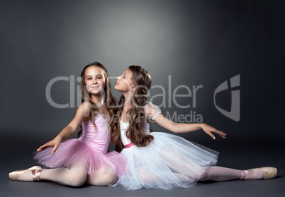 Two beautiful young ballerinas posing at camera