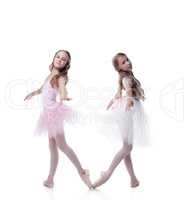 Two pretty girlfriends-ballerinas posing at camera