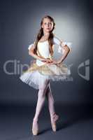 Graceful long-haired ballerina posing at camera