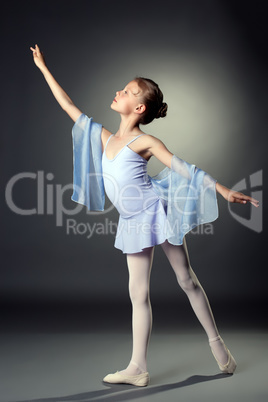 Image of graceful little dancer on gray backdrop