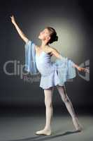 Image of graceful little dancer on gray backdrop