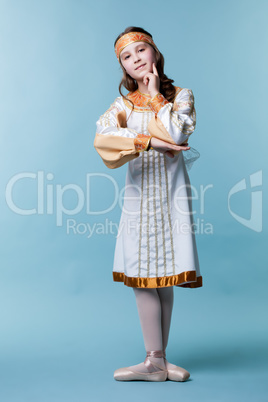 Lovely ballerina in folk costume posing at camera