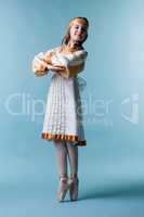 Cute little ballerina posing in folk dress