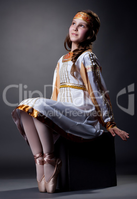 Dreamy little ballerina posing in folk dress