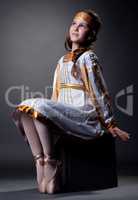 Dreamy little ballerina posing in folk dress