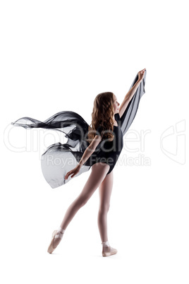 Smiling curly ballerina dancing with cloth