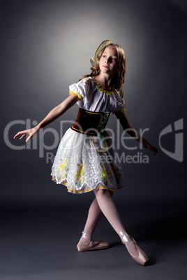 Thoughtful young ballerina dancing in folk dress