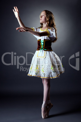 Image of curly ballerina posing in folk dress