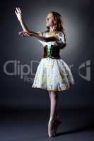 Image of curly ballerina posing in folk dress