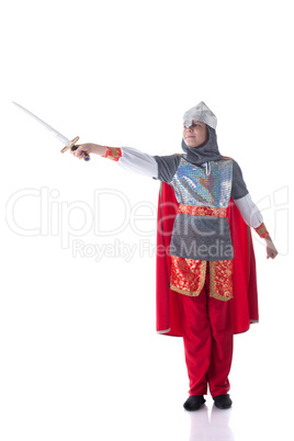 Smiling boy posing dressed as knight with sword