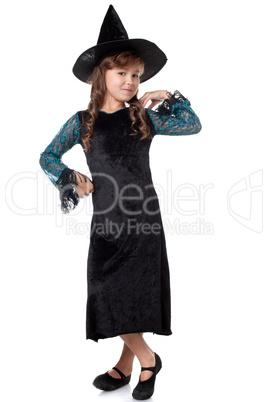 Elegant little girl posing dressed as witch