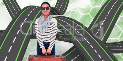 Composite image of asian woman with luggage looking at the camer
