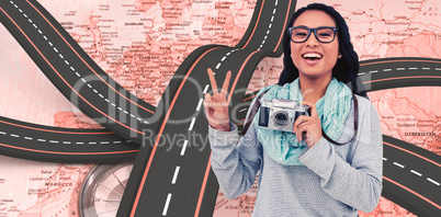 Composite image of asian woman holding digital camera and making