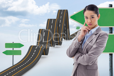 Composite image of portrait of a young businesswoman thinking