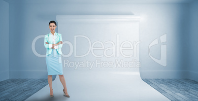 Composite image of elegant businesswoman with crossed arms