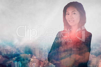 Composite image of smiling businesswoman with crossed arms