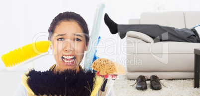 Composite image of very stressed woman with cleaning tools