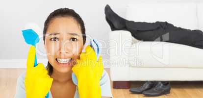 Composite image of distressed woman holding cloth and scrubbing