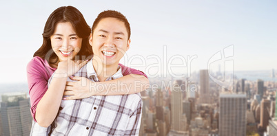 Composite image of smiling man gives girl a piggy back