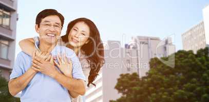 Composite image of smiling couple holding each other