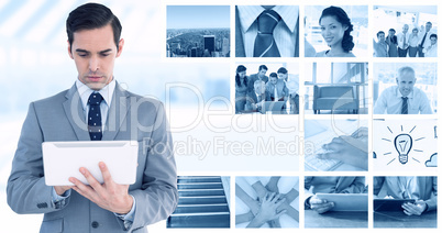 Composite image of businessman holding a tablet computer