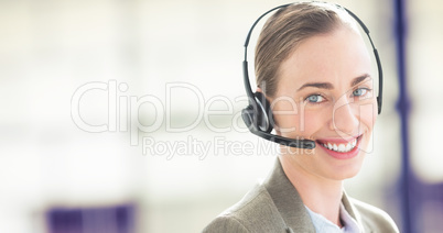 Composite image of smiling businesswoman with headset using comp