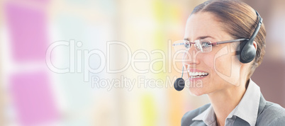 Composite image of businesswoman wearing headset