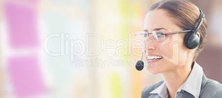 Composite image of businesswoman wearing headset