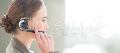 Composite image of smiling businesswoman with headset using comp