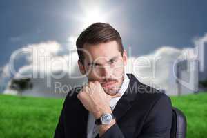 Composite image of cheerful businessman posing with hand on chin