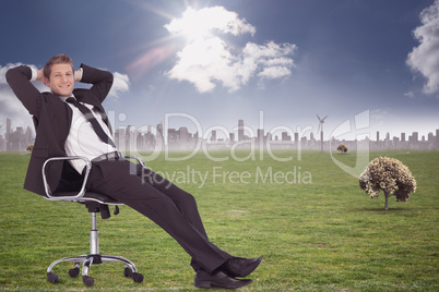 Composite image of businessman relaxing in swivel chair