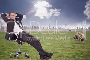 Composite image of businessman relaxing in swivel chair