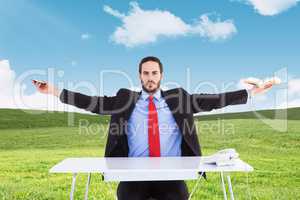 Composite image of unsmiling businessman sitting with arms outst
