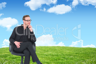 Composite image of thoughtful businessman sitting on a swivel ch